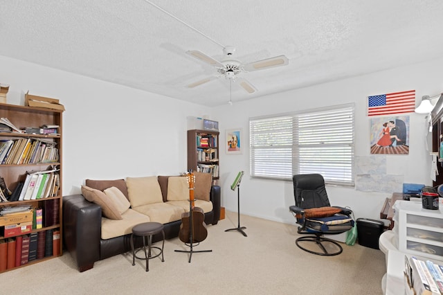 interior space with a ceiling fan, carpet flooring, and a textured ceiling