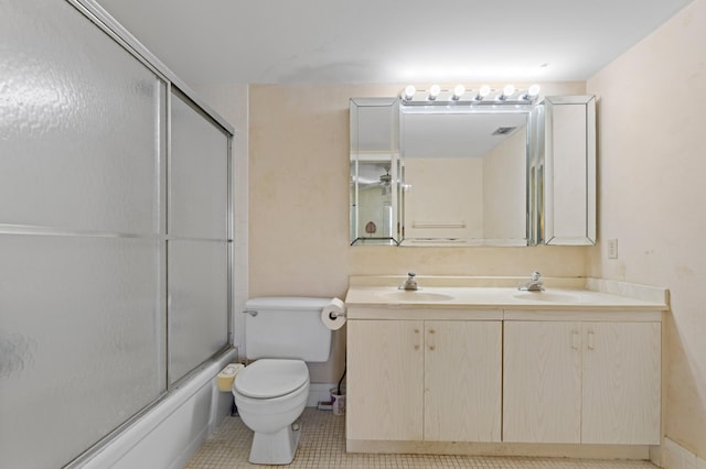 bathroom with toilet, a sink, double vanity, and enclosed tub / shower combo