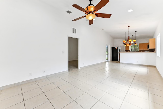 9827 Galleon Dr, West Palm Beach, FL 33411 - unfurnished living room featuring light tile patterned floors, visible vents, lofted ceiling, and ceiling fan with notable chandelier