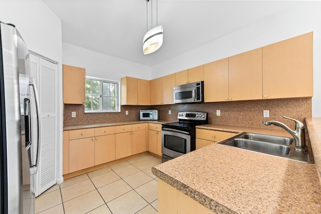 9827 Galleon Dr, West Palm Beach, FL 33411 - kitchen with light tile patterned floors, light brown cabinetry, a sink, stainless steel appliances, and decorative backsplash