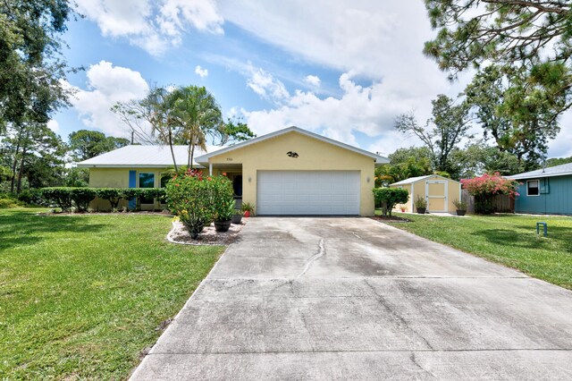 ranch-style home featuring a front lawn, driveway, stucco siding, and an attached garage
