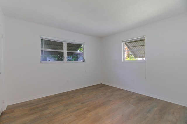 4375 Forest Ln, Palm Springs, FL 33406 - spare room with plenty of natural light, wood finished floors, and baseboards