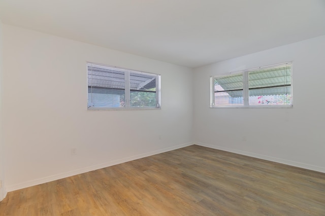 4375 Forest Ln, Palm Springs, FL 33406 - unfurnished room with healthy amount of natural light, light wood-type flooring, and baseboards