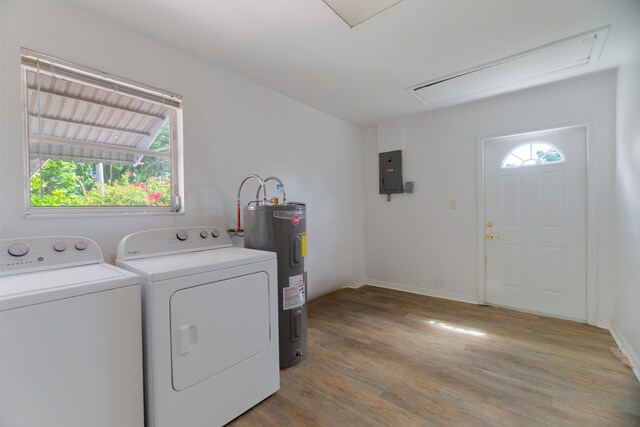 4375 Forest Ln, Palm Springs, FL 33406 - laundry room featuring attic access, water heater, washing machine and dryer, electric panel, and light wood-style floors