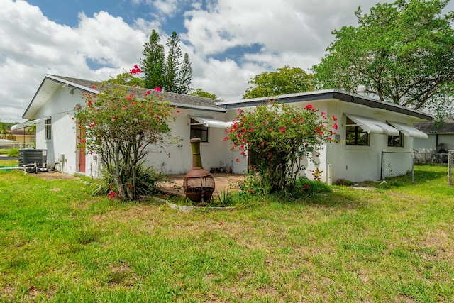 4375 Forest Ln, Palm Springs, FL 33406 - back of house with a lawn, central AC, and stucco siding