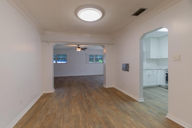 4375 Forest Ln, Palm Springs, FL 33406 - hall with arched walkways, wood finished floors, ornamental molding, and baseboards