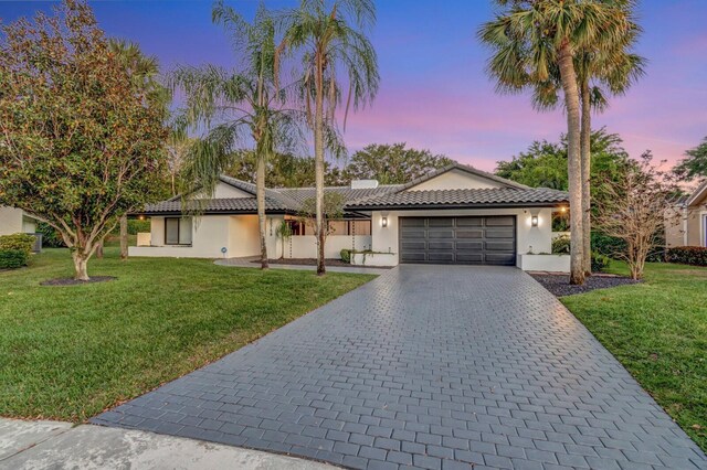 20758 Sorolla Ter, Boca Raton, FL 33433 - single story home with a front yard, stucco siding, a tiled roof, decorative driveway, and a garage