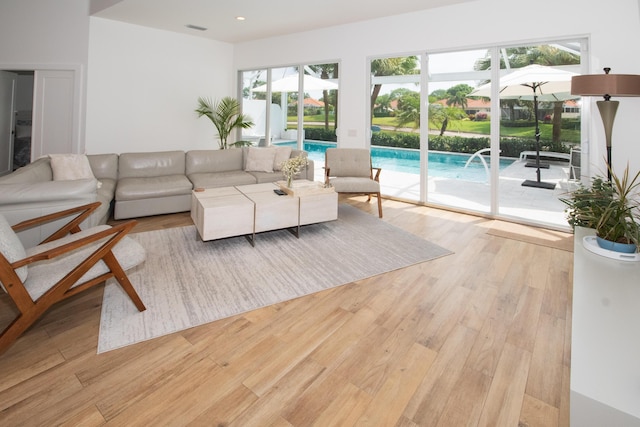 living room with visible vents, wood finished floors, and recessed lighting