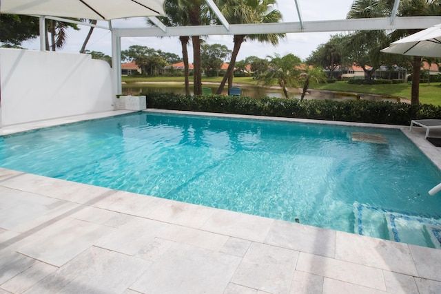 pool with a water view, a lanai, and a patio