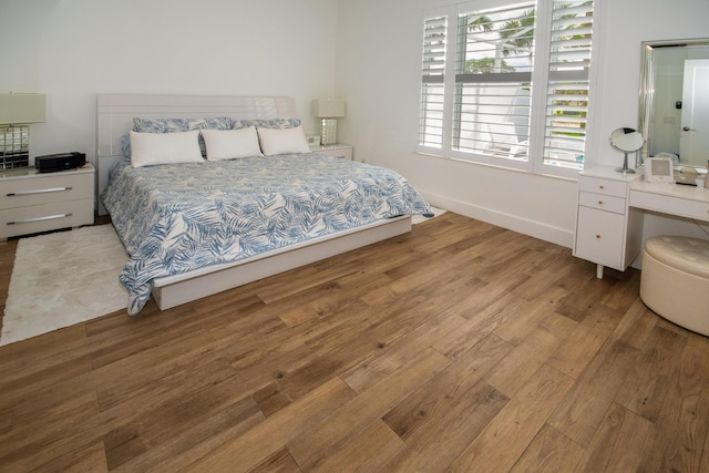 bedroom featuring baseboards and wood finished floors