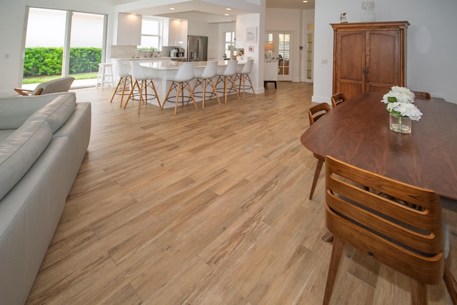dining space with light wood-type flooring and recessed lighting