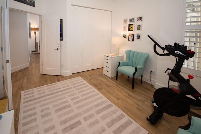 sitting room featuring baseboards and light wood-style floors