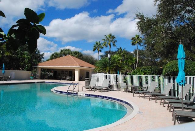 pool with fence and a patio area