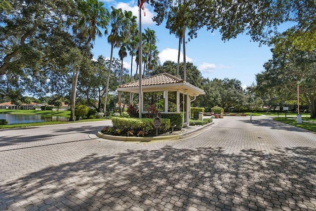 view of road featuring a water view and curbs