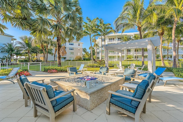 view of patio / terrace with a pergola, fence, and an outdoor fire pit