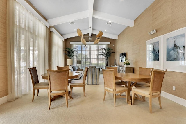 carpeted dining area with baseboards, vaulted ceiling with beams, a ceiling fan, and visible vents