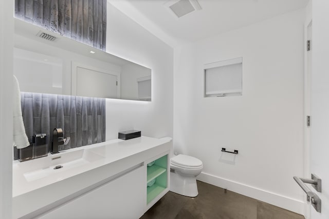 7047 San Sebastian Cir, Boca Raton, FL 33433 - bathroom featuring toilet, vanity, baseboards, and concrete floors