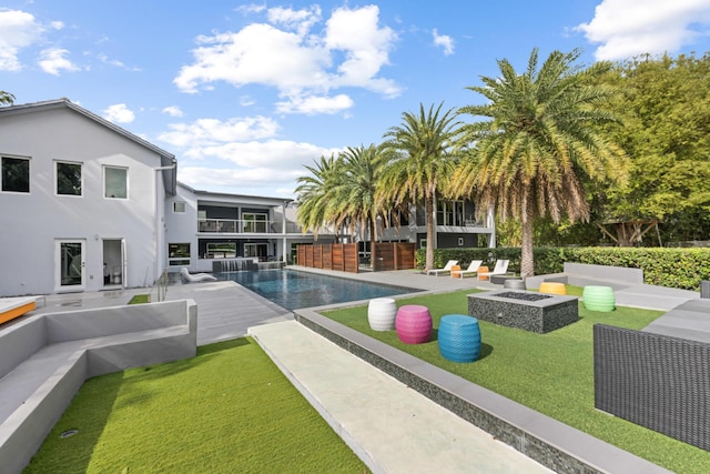 7047 San Sebastian Cir, Boca Raton, FL 33433 - view of pool with an outdoor living space with a fire pit, a lawn, and a patio
