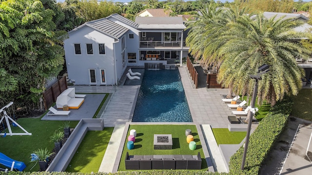 7047 San Sebastian Cir, Boca Raton, FL 33433 - back of house with stucco siding, an outdoor pool, a patio area, and a balcony