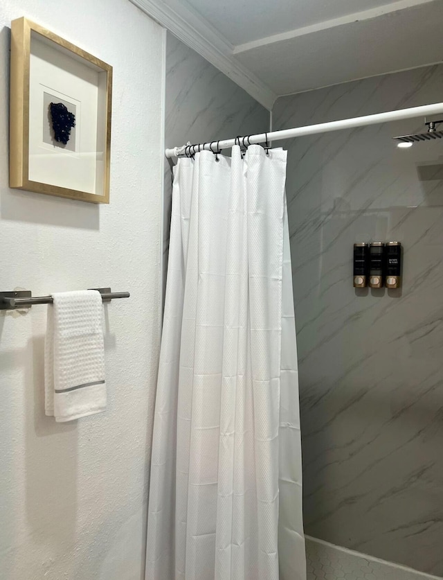 bathroom featuring ornamental molding and a shower with shower curtain