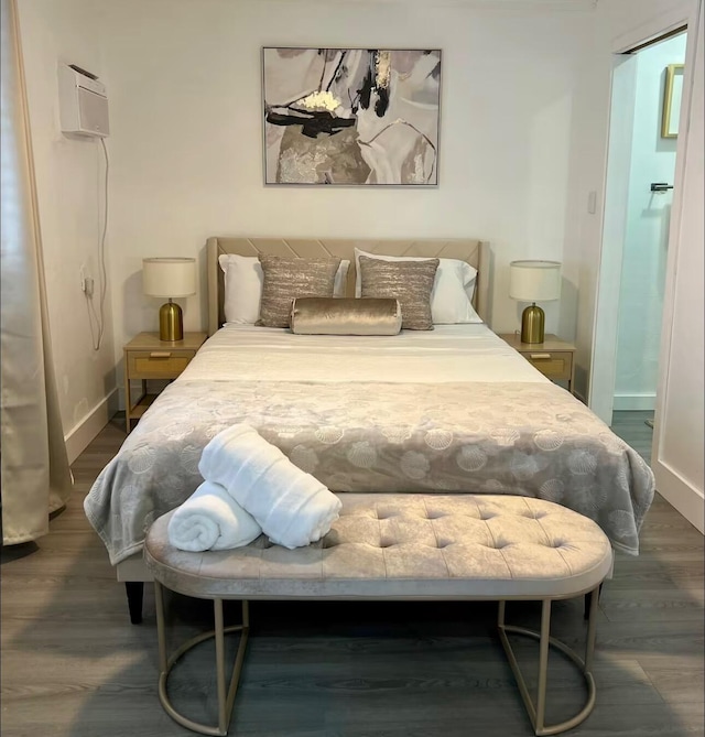 bedroom featuring baseboards and wood finished floors