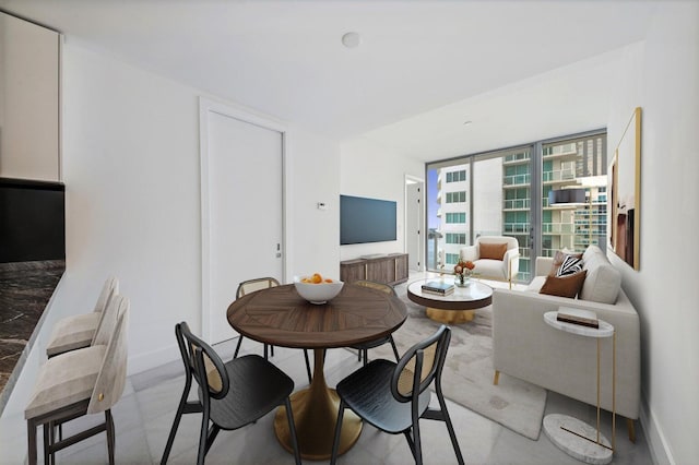 dining room with baseboards and expansive windows
