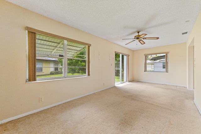 6472 Overland Dr, Delray Beach, FL 33484 - empty room with baseboards, carpet flooring, a textured ceiling, a ceiling fan, and visible vents