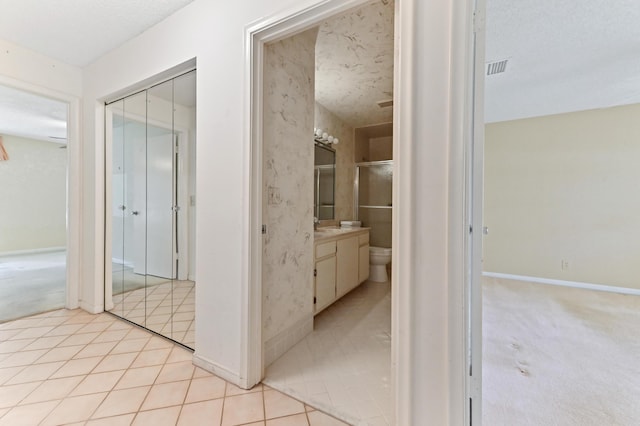 6472 Overland Dr, Delray Beach, FL 33484 - hallway featuring a sink, light tile patterned floors, baseboards, and light colored carpet