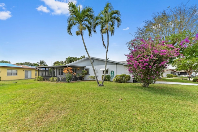 6472 Overland Dr, Delray Beach, FL 33484 - mid-century home with a front lawn and a sunroom