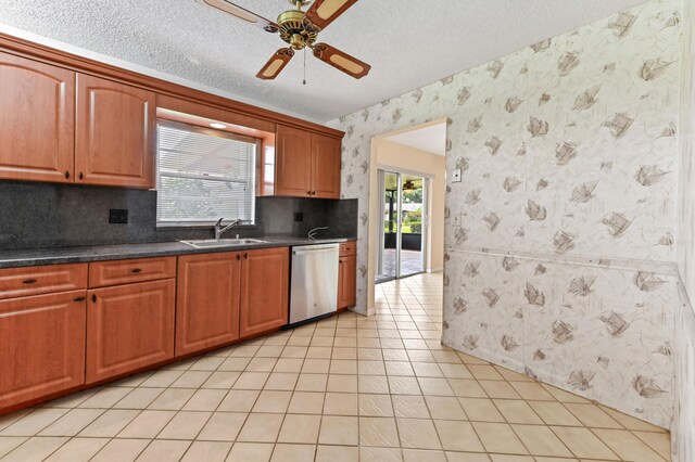 6472 Overland Dr, Delray Beach, FL 33484 - kitchen with a sink, ceiling fan, a textured ceiling, wallpapered walls, and stainless steel dishwasher