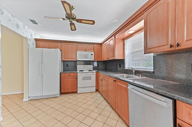 6472 Overland Dr, Delray Beach, FL 33484 - kitchen featuring white appliances, a ceiling fan, visible vents, a sink, and dark countertops