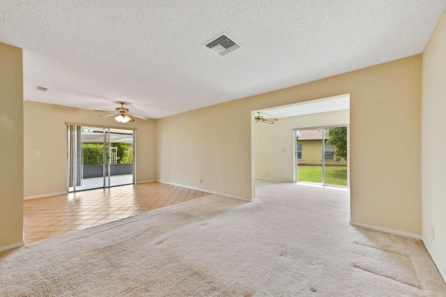 6472 Overland Dr, Delray Beach, FL 33484 - empty room with visible vents, ceiling fan, carpet flooring, and tile patterned flooring