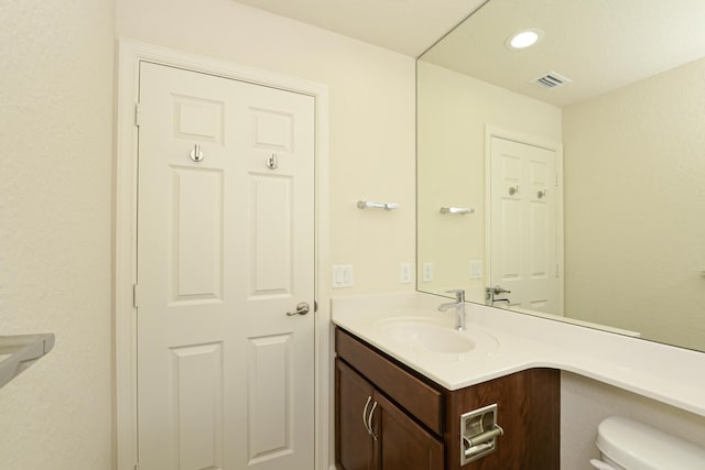 6763 Mar Pacifico, Fort Pierce, FL 34950 - half bathroom with visible vents, toilet, recessed lighting, and vanity