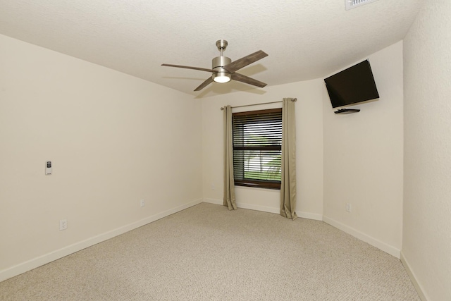 6763 Mar Pacifico, Fort Pierce, FL 34950 - spare room with baseboards, a textured ceiling, a ceiling fan, and light carpet