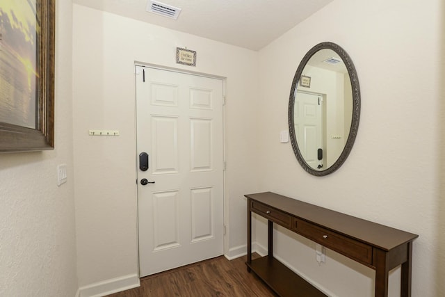 entryway with baseboards, dark wood-style flooring, and visible vents