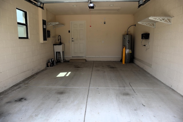 6763 Mar Pacifico, Fort Pierce, FL 34950 - garage with concrete block wall, electric water heater, and a garage door opener