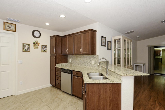 6763 Mar Pacifico, Fort Pierce, FL 34950 - kitchen with tasteful backsplash, a sink, visible vents, dishwasher, and a peninsula