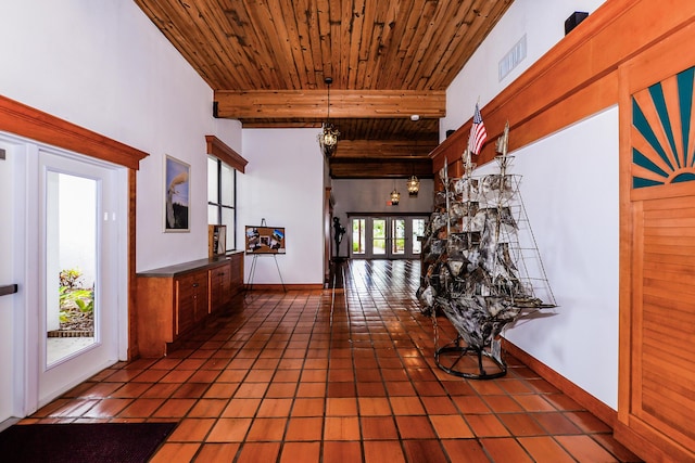 6763 Mar Pacifico, Fort Pierce, FL 34950 - hallway featuring tile patterned floors, beamed ceiling, wood ceiling, and baseboards
