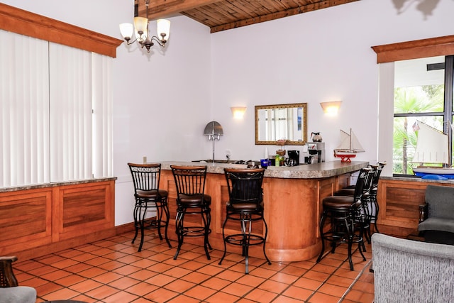 6763 Mar Pacifico, Fort Pierce, FL 34950 - bar with light tile patterned flooring, a bar, wooden ceiling, vaulted ceiling with beams, and a notable chandelier