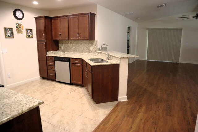 6763 Mar Pacifico, Fort Pierce, FL 34950 - kitchen featuring decorative backsplash, stainless steel dishwasher, a sink, a ceiling fan, and a peninsula