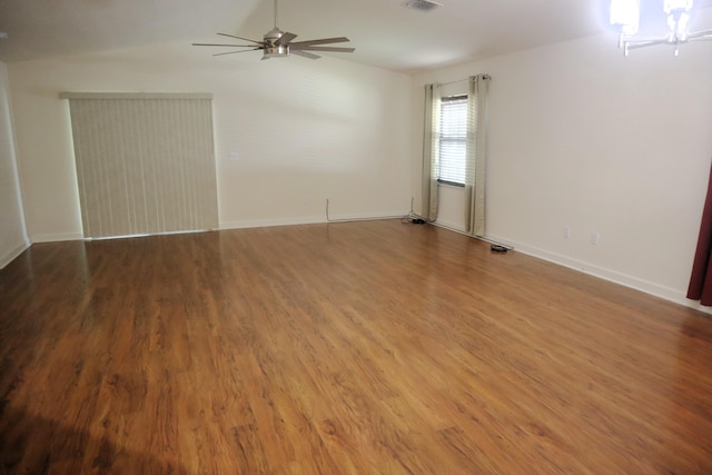 6763 Mar Pacifico, Fort Pierce, FL 34950 - unfurnished room featuring vaulted ceiling, ceiling fan with notable chandelier, baseboards, visible vents, and wood finished floors