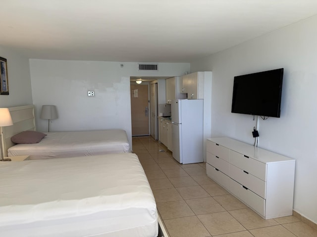 19201 Collins Ave Unit 448, Sunny Isles Beach, FL 33160 - bedroom with freestanding refrigerator, light tile patterned floors, and visible vents