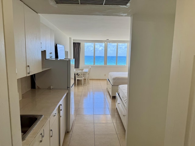 19201 Collins Ave Unit 448, Sunny Isles Beach, FL 33160 - interior space featuring freestanding refrigerator, light tile patterned floors, and a sink