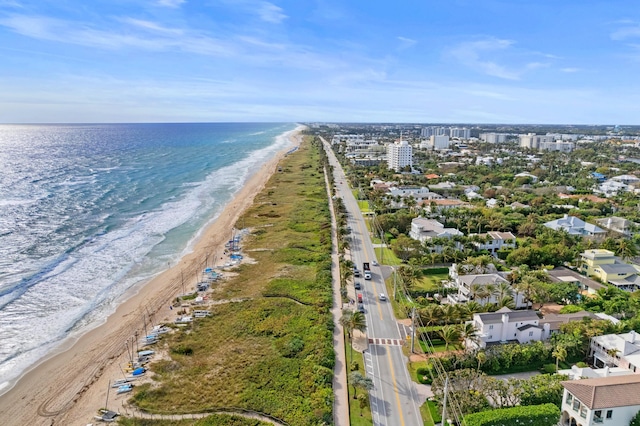 drone / aerial view with a water view and a beach view