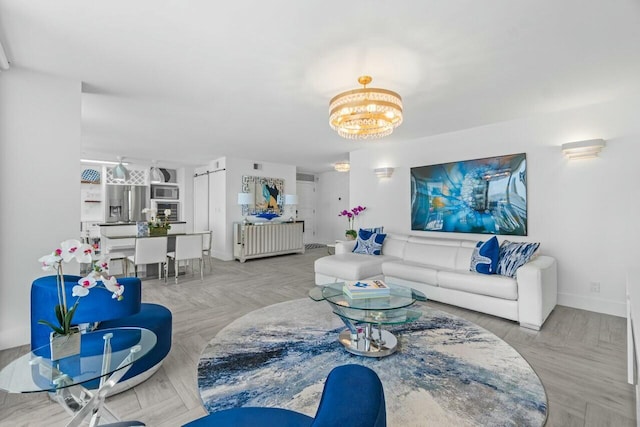 living area with baseboards, a notable chandelier, and visible vents