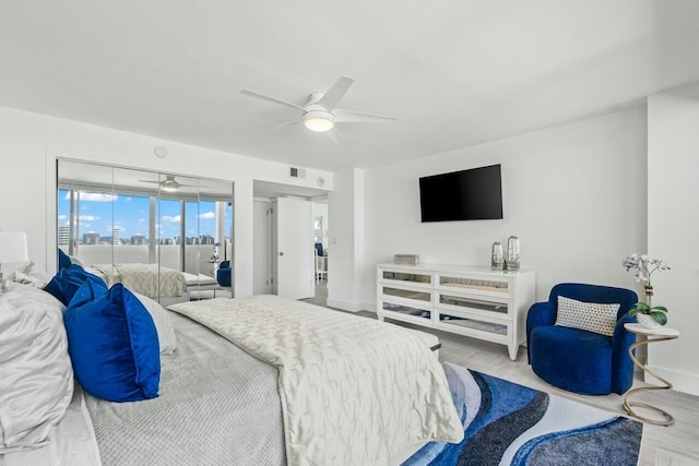 bedroom featuring a ceiling fan, access to exterior, and wood finished floors