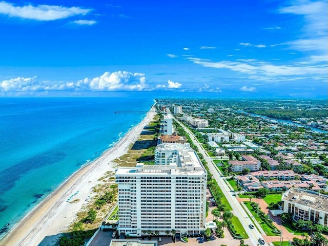 bird's eye view with a water view, a view of the beach, and a view of city