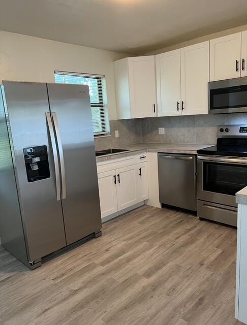kitchen with white cabinetry, light countertops, and appliances with stainless steel finishes
