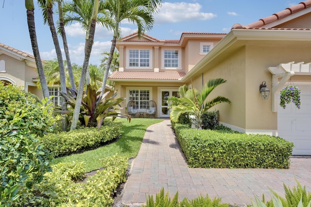 12479 Aviles Cir, Palm Beach Gardens, FL 33418 - entrance to property with a tiled roof and stucco siding