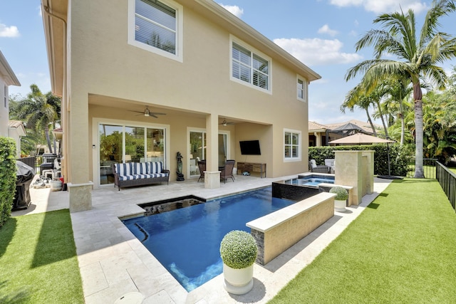 12479 Aviles Cir, Palm Beach Gardens, FL 33418 - rear view of house featuring stucco siding, ceiling fan, a patio, and a pool with connected hot tub